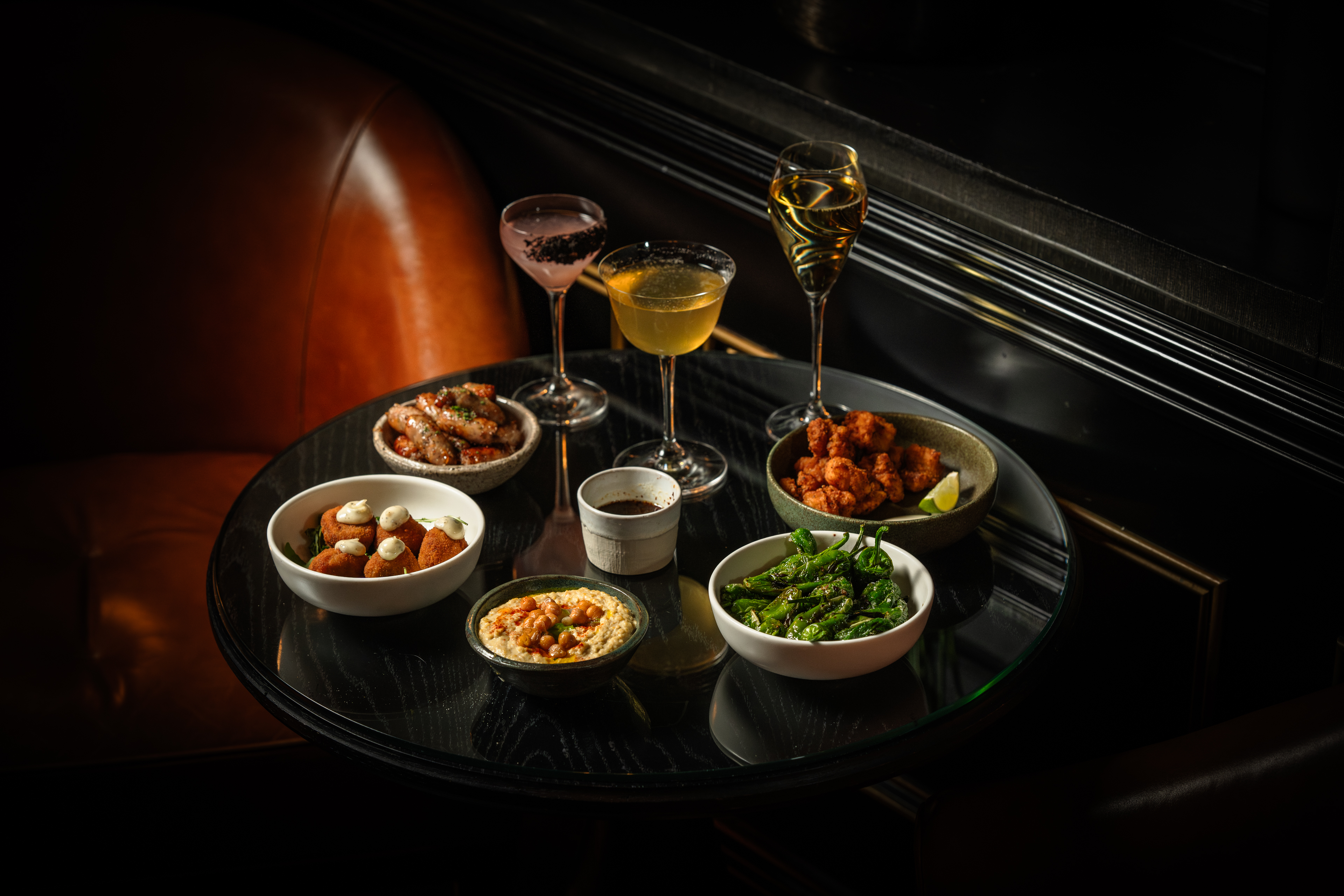 Chelsea Bar, bar table with small dishes and cocktails